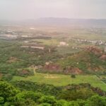 A stunning aerial view of a Kondapalli covered in lush greenery during the daytime.