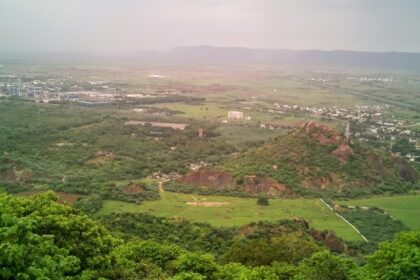 A stunning aerial view of a Kondapalli covered in lush greenery during the daytime.