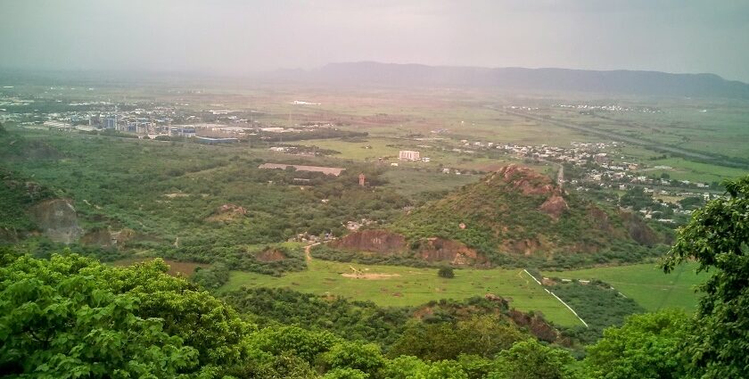 A stunning aerial view of a Kondapalli covered in lush greenery during the daytime.