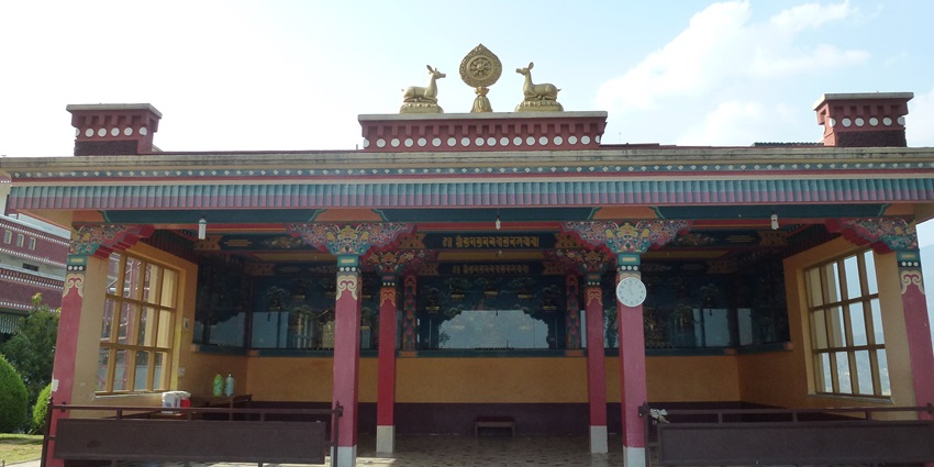 The image shows Kopan Monastery, a Tibetan Buddhist monastery nestled in the hills of Nepal.