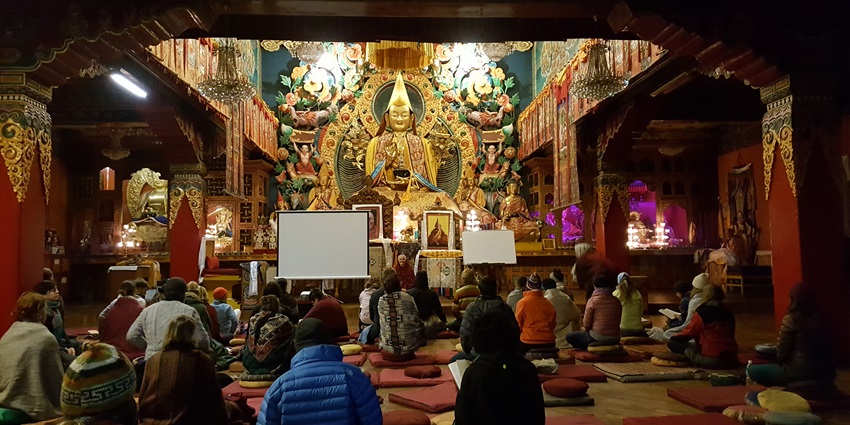 The Kopan Monastery, a Buddhist monastery located in Kathmandu, Nepal, set against mountains.