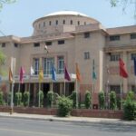 View of one of the Kota museums, surrounded by trees and colourful flags