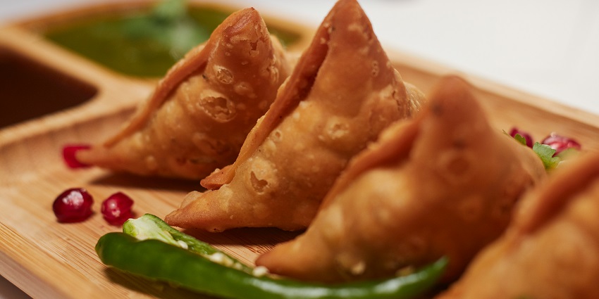 Krishna Fast Food stall has a variety of fast food items like vada pav and samosas.