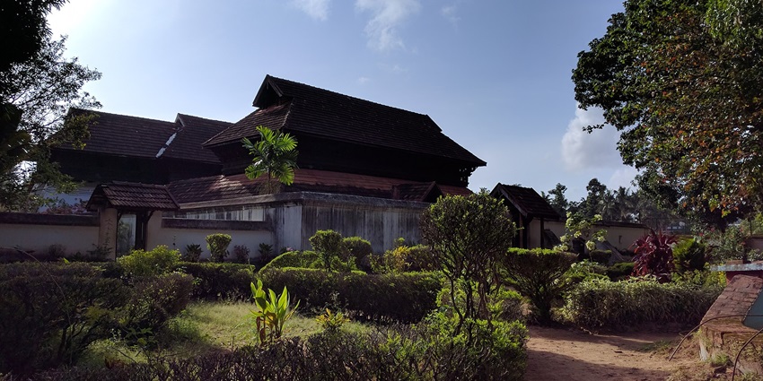 Krishnapuram Palace's grand architecture surrounded by lush gardens in Kerala, India.
