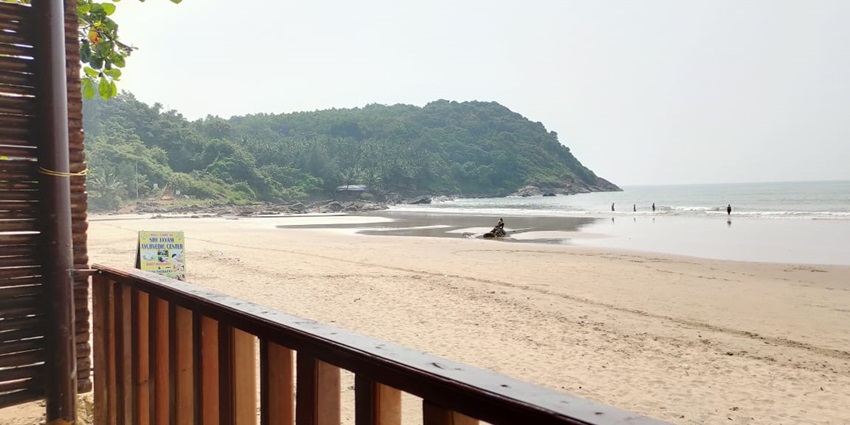 The long stretchy beach is surrounded by dense forest and rocky hills.