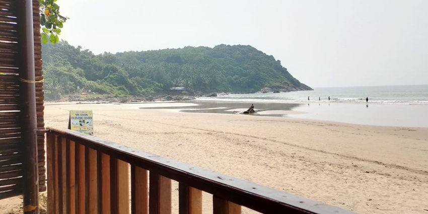 The beach features the sunset with vibrant colours illuminating the sky and the water.