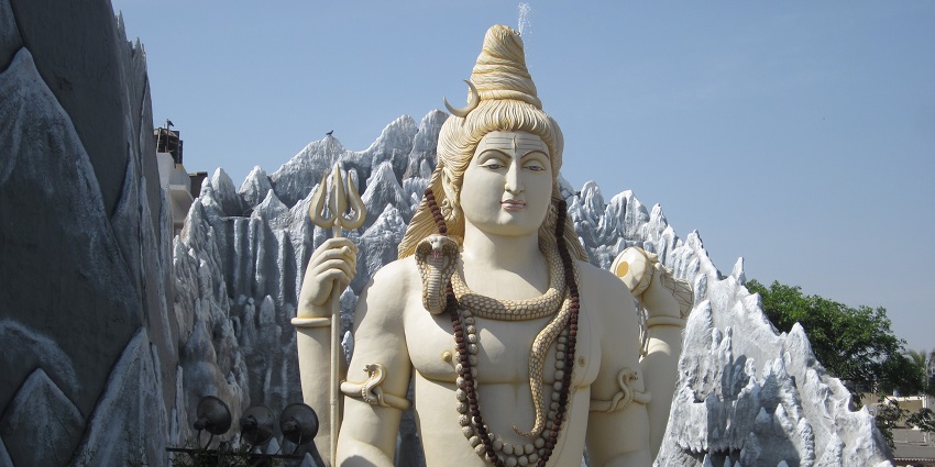 Statue of Lord Shiva at one of the temples in Mount Abu in a meditative pose with a snake coiled.