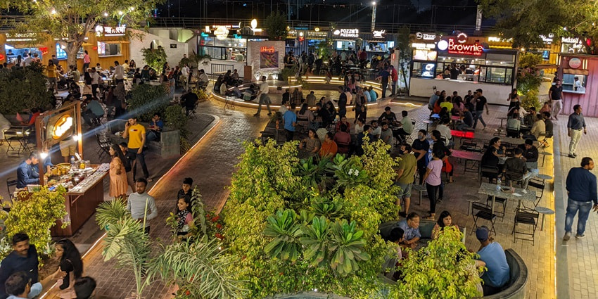 A picture of a street market in Ahmedabad with many people shopping from the stalls