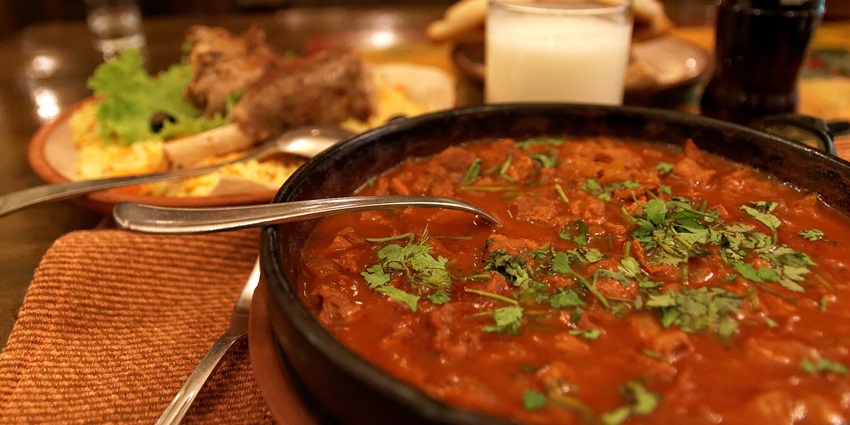 An image of delectable Laal Maas: spicy mutton curry from Bikaner with red chillies.