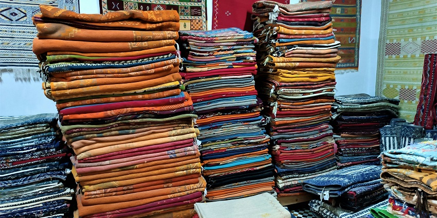 A glimpse of colourful clothes beautifully piled up and kept on a table in Lajpat Nagar.