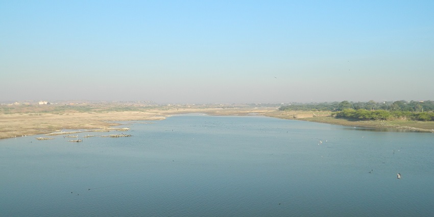 A scenic view of Lake Pichola with its calm waters and surrounding greenery