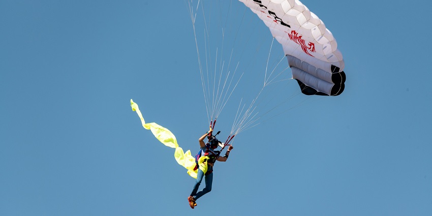 A person flying through the sky, enjoying a thrilling descent with scenic views below.