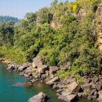 Serene water past a cliff in the dense forest of Lakhari Valley Wildlife Sanctuary