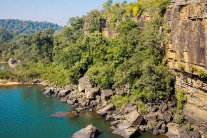 Serene water past a cliff in the dense forest of Lakhari Valley Wildlife Sanctuary