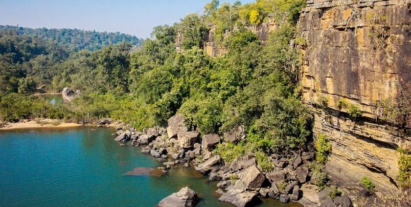 Serene water past a cliff in the dense forest of Lakhari Valley Wildlife Sanctuary