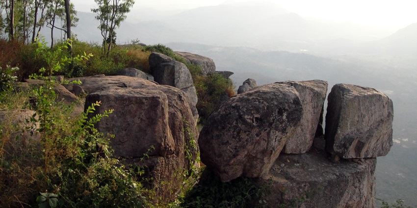 A glimpse of rocky cliffs surrounded by majestic peaks in Lambasingi in Andhra Pradesh.
