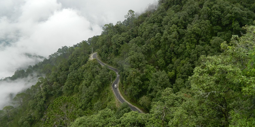 A panoramic view of Lansdowne, one of the picturesque hill stations near Gurugram, with snow-capped peaks in the distance.