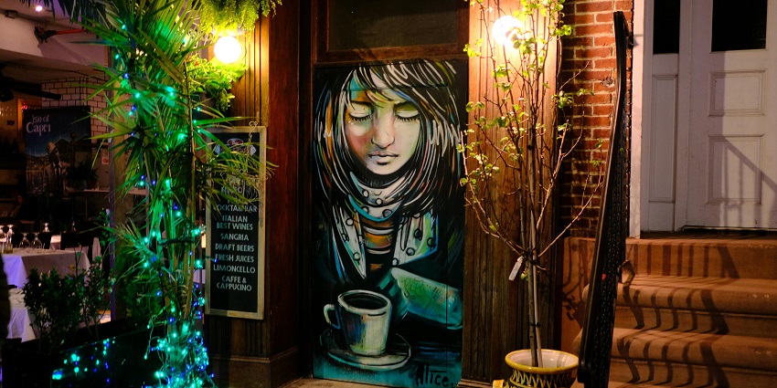 A picture of a wall art at a night cafe in Pushkar, with a decorated ambience