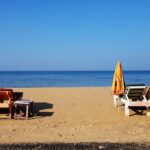 A tranquil view of Keri Beach with soft sands and gentle waves in North Goa, India.