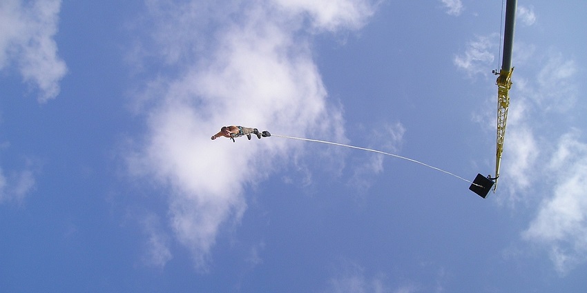 View of an adventure seeker bungee jumping in Manali against the clear blue sky