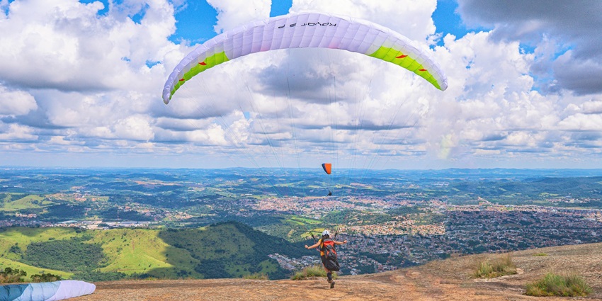 A person paragliding over clouds in the daytime and feeling the breeze in Kasauli.