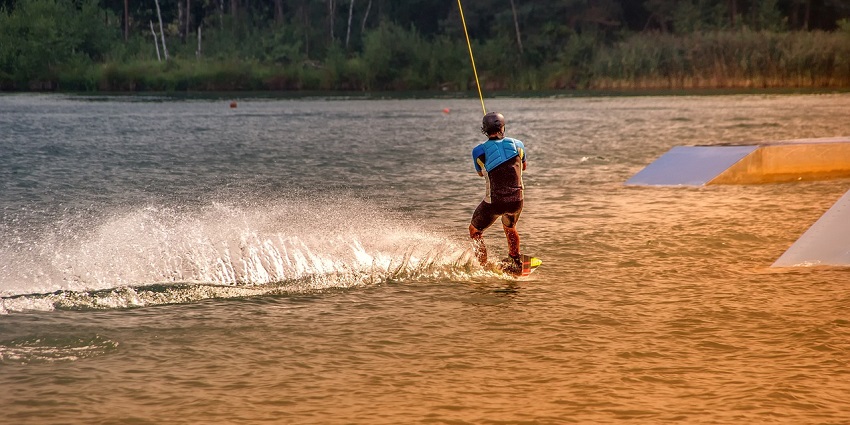 An image of a boy in the middle of the ocean performing water sports in Krabi, Thailand.