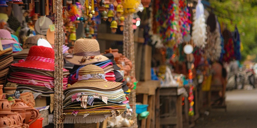 Image of vibrant market, surrounded by colourful stalls and lively atmosphere.