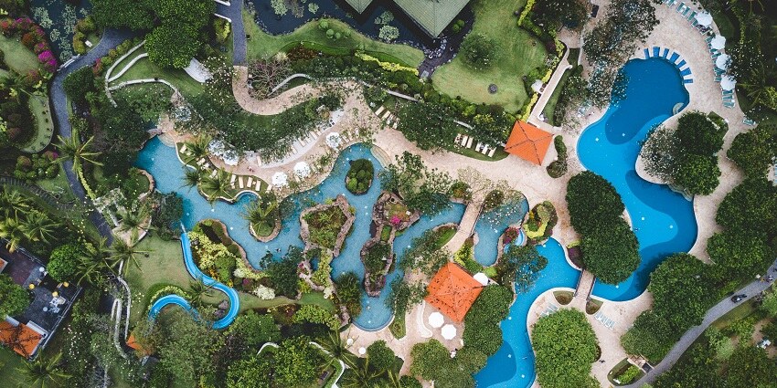 A scenic view with greenery justifying the serene location of Swapna Srushti Water Park.