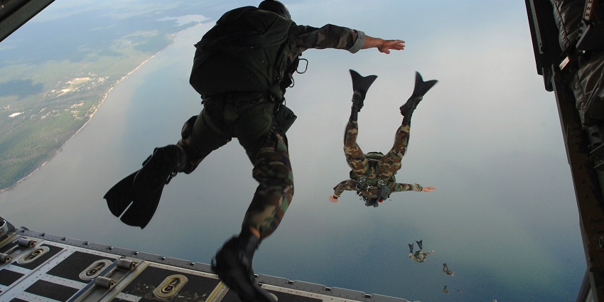 A stunning view of a group of people jumping out of an aeroplane to enjoy an activity.