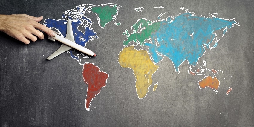 A stunning view of a colourful map drawn on a blackboard with a toy aeroplane on it.