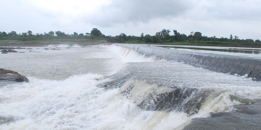 The water flowing through the dam at Par river in Panchlai town of Valsad district.