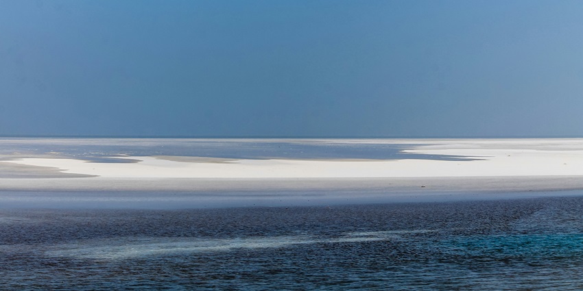 An image of an accumulation of salt in between the ocean looks like a small island, Kutch.
