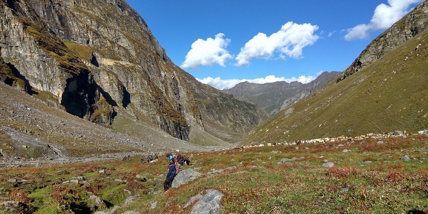 Wide angle of tourist trekking through the verdant meadows offering panoramic views