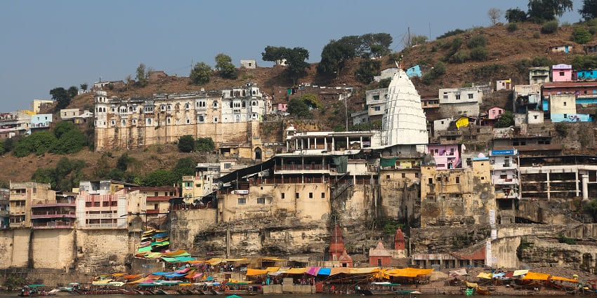 An exterior view of Omkareshwar Temple in Madhya Pradesh features its intricate carvings and traditional architectural design.