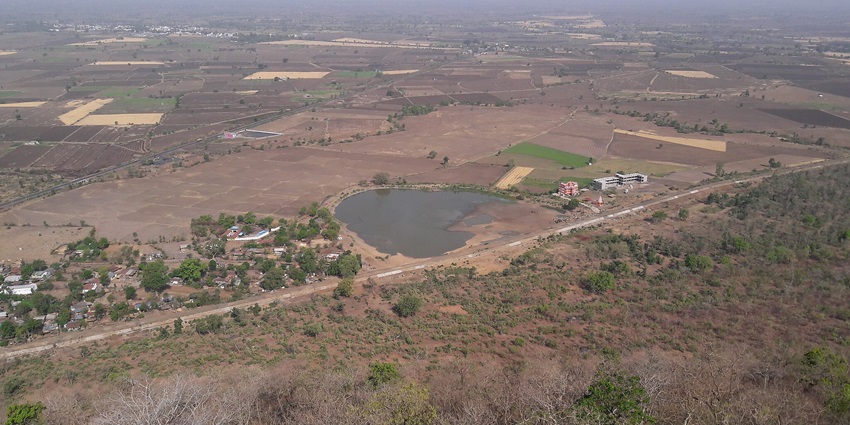 Scenic view of the natural beauty surrounding the famous Salkanpur Temple, featuring lush green hills and dense forests.
