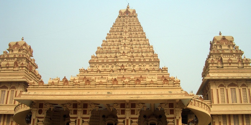 Wide angle view of the entrance of the temple, carved pillars and roof with stairs leading inside