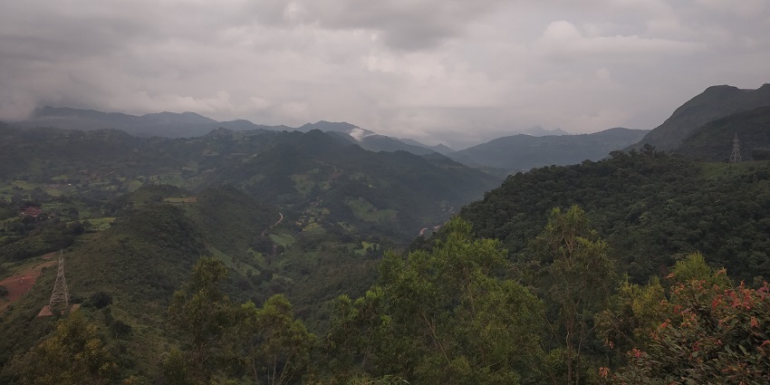 Iamge of Araku Valley during day time surrounded by lush green mountains under clear blue sky