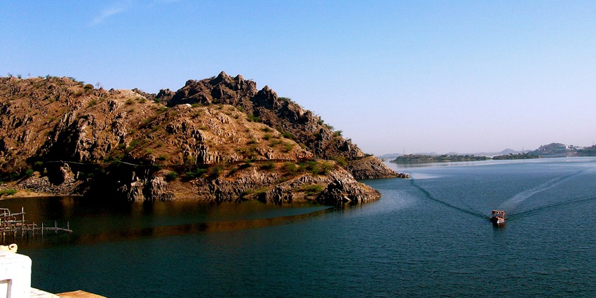 Expansive view of the lake showcasing lush greenery all around it