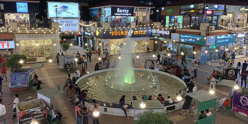 A decorative fountain in Gurgaon, surrounded by vibrant landscaping.