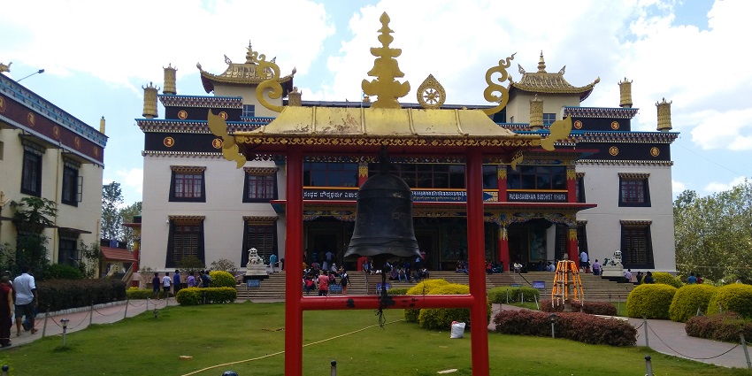 The temple bell in front of Padmasambhava Mahavihara Monastery in the background
