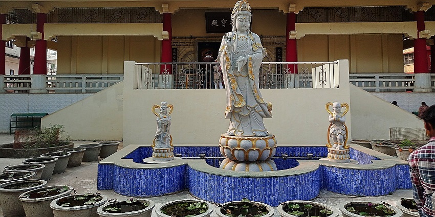 A standing Buddhist sculpture in a temple complex at Bodh Gaya in Tergar Monastery.