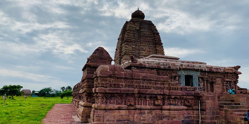 A scenic view of the Sangameshwara Temple located on the sprawling green fields.