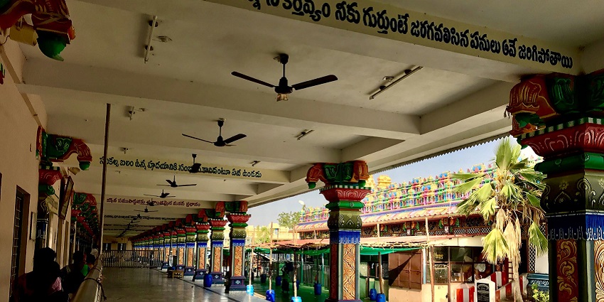 Corridor in Penuganchiprolu Temple with detailed carvings and traditional architectural elements