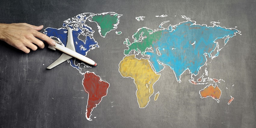 A wonderful view of a colourful map drawn on a board with a toy aeroplane on it.