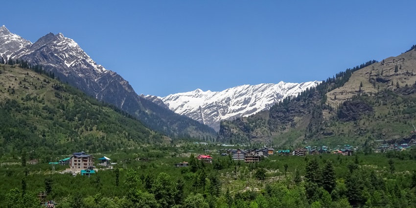 View of Kullu Valley near Manali, showcasing lush green hills and mountains.