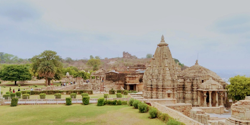 The Chittorgarh fort is surrounded by nature and greenery with a beautiful Hindu temple in the background