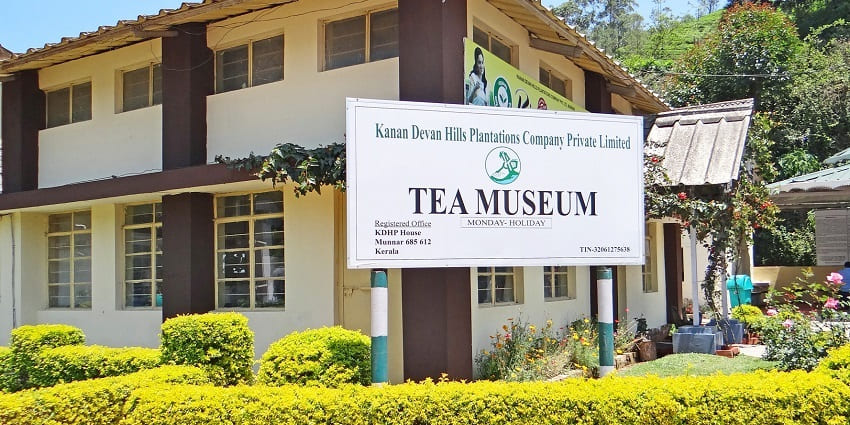 A frontal view of a tea museum surrounded by big tea gardens and plantations