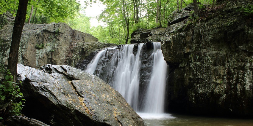 A glimpse of shimmering waters cascading through rocky cliffs at the Lodh Falls.