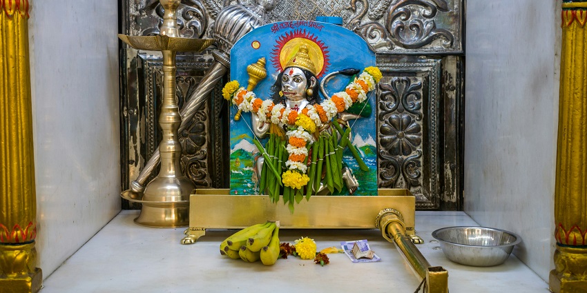 A serene shrine featuring a statue of a Hindu god - Hanuman Temples in Delhi.