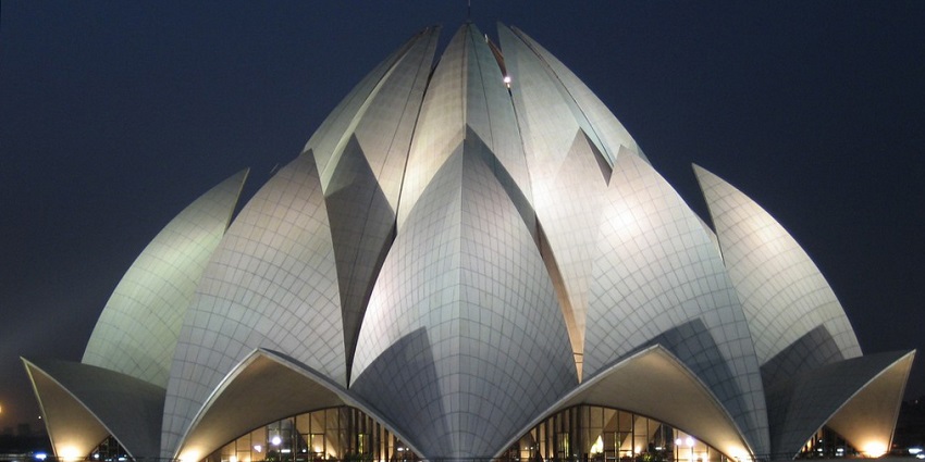 A picture of the Lotus Temple taken from a distance showing its frontal side during nighttime